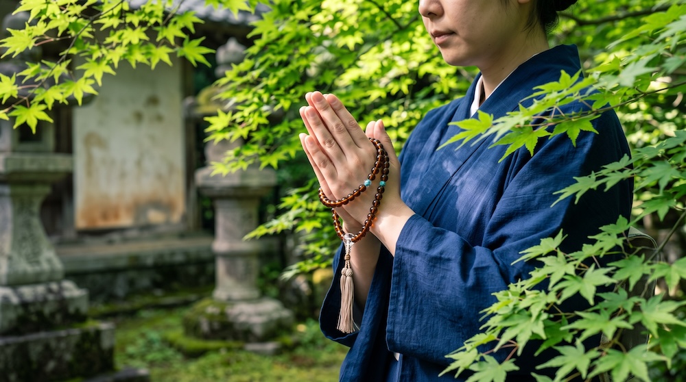 数珠を手に持ち合掌する清らかな手元